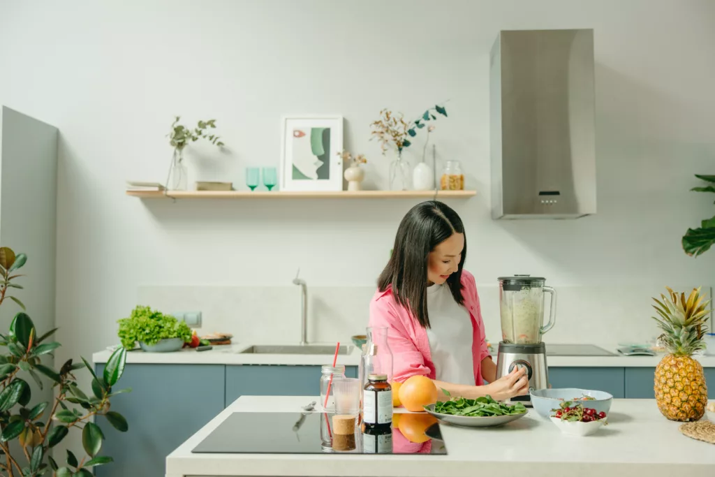 An Asian woman creating some kind of supplement.