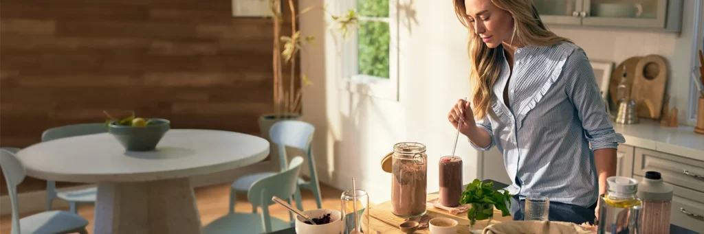 A young woman trying a shake from Team Beachbody